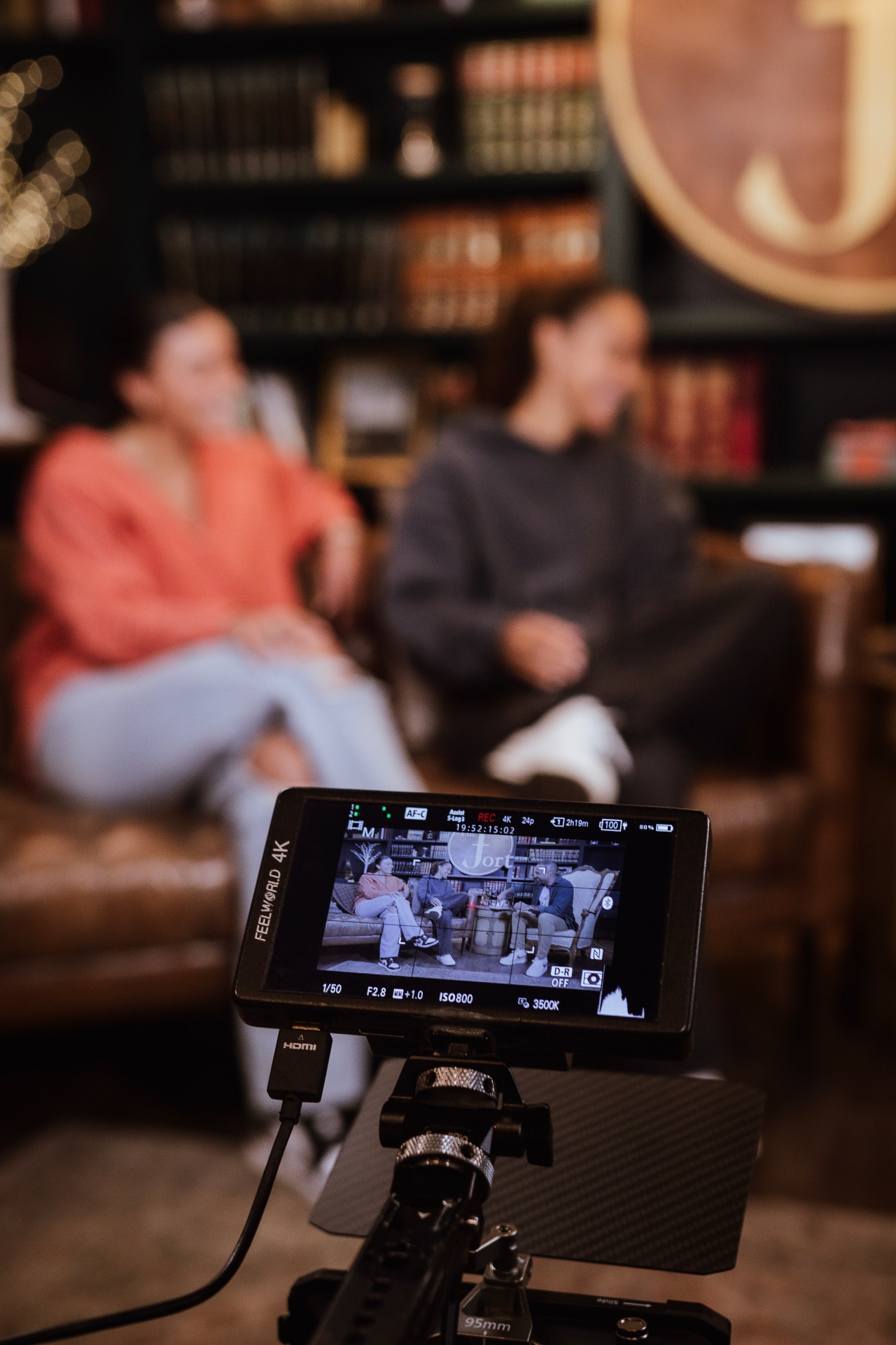 A FEELWORLD 4K monitor on the rig showing a live take, recording at 24p